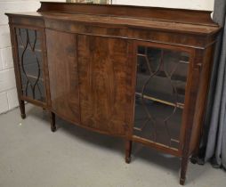 A mahogany sideboard, with two astragal glazed panel doors, flanking a bow front centre, raised on