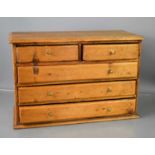 An antique pine collectors cabinet / apprentice piece chest of two over three long drawers with