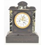 A French 19th century 8 day striking slate and marble mantel clock with visible Brocot escapement,