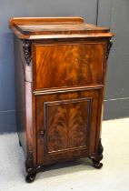 A 19th century mahogany music cabinet, the top section lifting up above a panelled flame mahogany