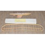 A Ben Buckle model aeroplane kit together with a model yacht hull.