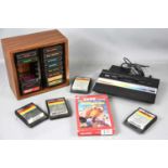 A vintage Atari 2600 games console and a quantity of games to include Star Voyager, Phoenix,