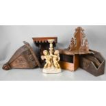 Three treen carved wall brackets, one terminating with a face mask, together with a letter rack,