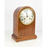 An Edwardian mahogany domed mantle clock, inlaid with boxwood stringing, the convex glass door
