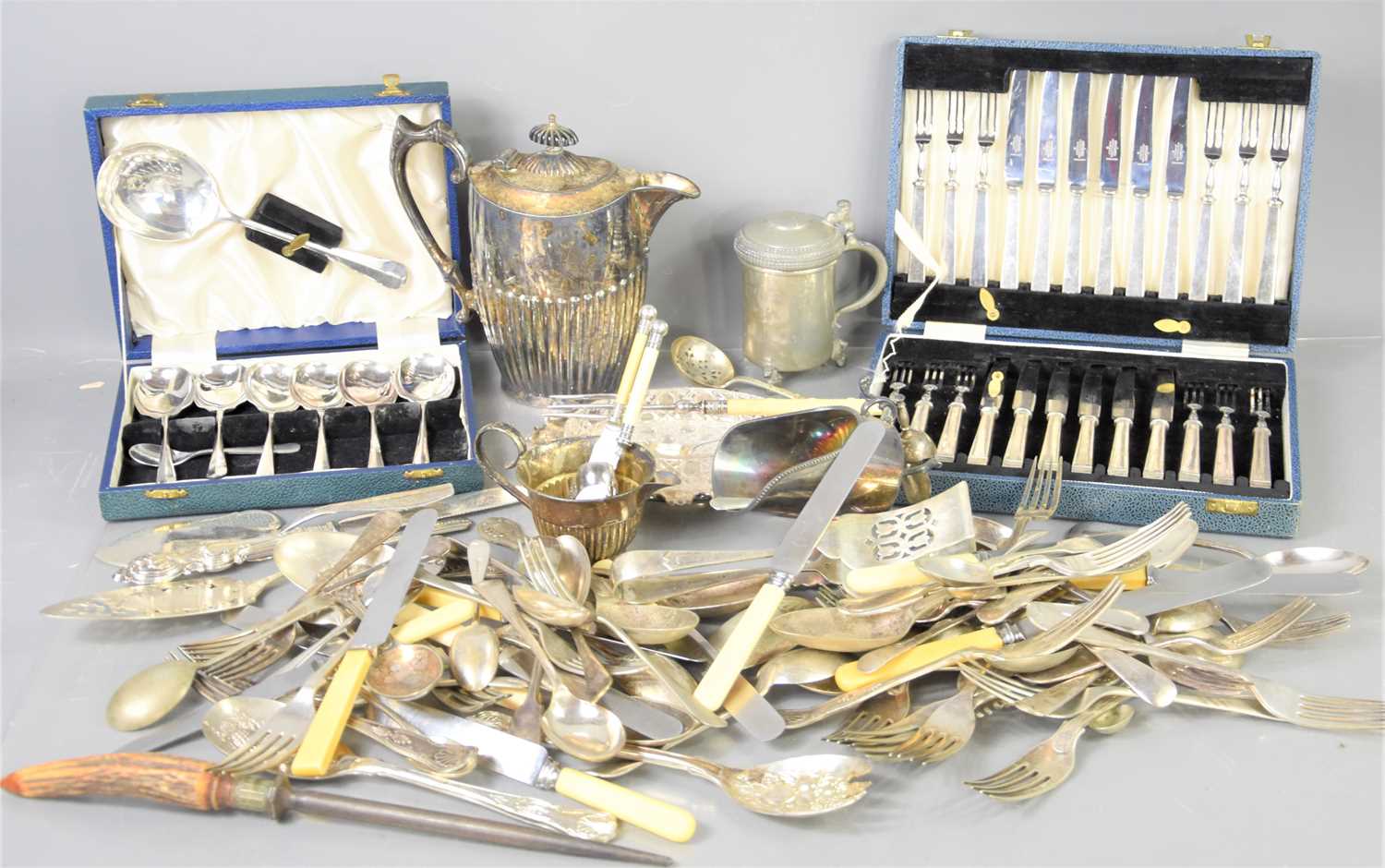 A group of silver plated items to include a boxed set of Mappin and Webb cake knives and forks,