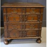 An 18th century oak geometric moulded splitter chest, with four long drawers with brass drop