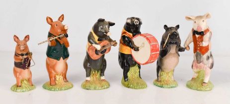A group of Beswick pottery musical pigs, including guitarist, drummer, flautist and others. (6)