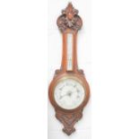 A Victorian carved oak cased aneroid barometer, signed Beasley and Son, 92cms tall