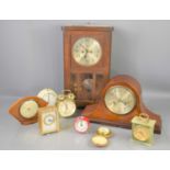 A group of clocks to include an onyx mantle clock, Smiths alarm clock, oak cased wall clock.