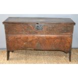 A 17th century boarded oak coffer with candle box and carving to the front.