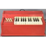 A vintage electric childs organ possibly made by Magnus together with a push penny board.