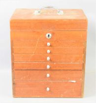 A mid 20th century oak portable dentist cabinet with six graduating drawers each with glass