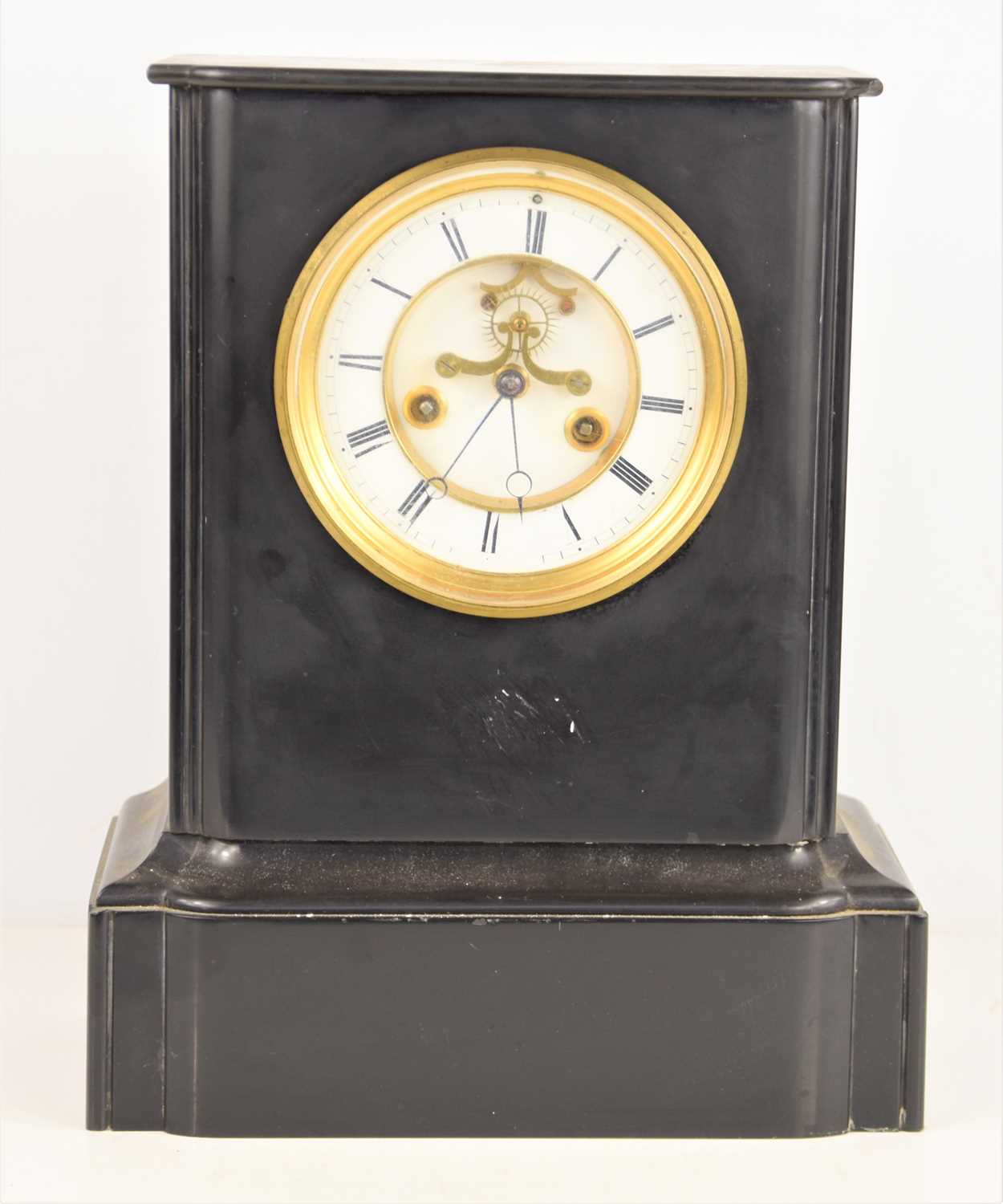 A late 19th century French slate mantle clock, the circular dial with Roman numerals with visible