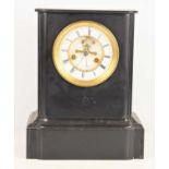 A late 19th century French slate mantle clock, the circular dial with Roman numerals with visible