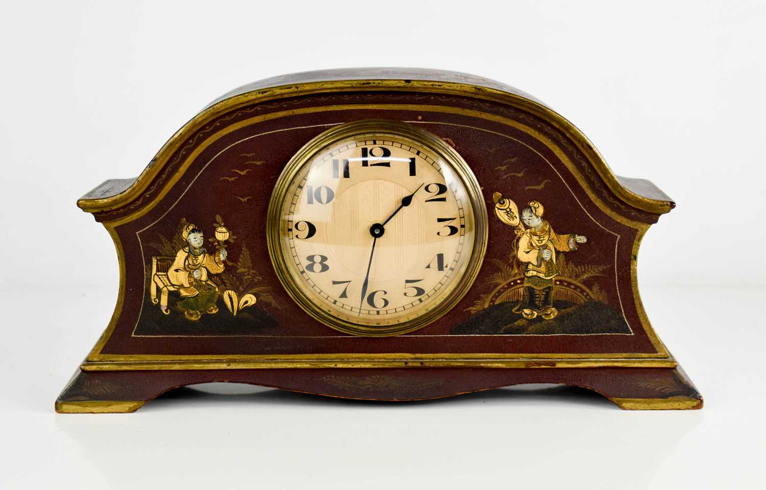 An early 20th century Chinoiserie mantle clock, with gilt arabic dial, the red lacquered case hand