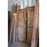 A large door and frame, the two panel door, together with sections of carved panels to form a