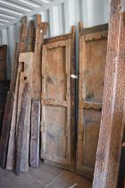 A large door and frame, the two panel door, together with sections of carved panels to form a