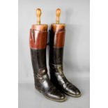 A pair of antique boot trees together with pair of leather gentleman's boots.