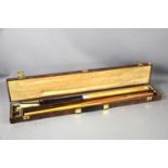 A vintage Goldmaster snooker cue in a hard case.