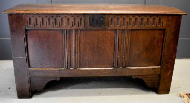 An 18th century oak coffer, with nulled frieze above three panels, raised on stile and bracket feet,
