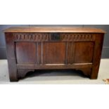 An 18th century oak coffer, with nulled frieze above three panels, raised on stile and bracket feet,