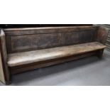 A long pine church pew, 82cm high by 222cm by 41cm deep.