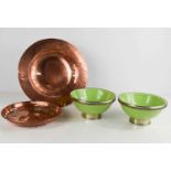 An Art Nouveau copper pierced bowl and copper charger together with two green pottery bowls with