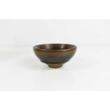 A Chinese stoneware rice bowl, with graduated dark grey/green and brown glaze.