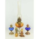 Four miniature paraffin lamps together with a Victorian brass lamp.