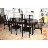 A Chinese black lacquered dining table with four chairs and two carvers.