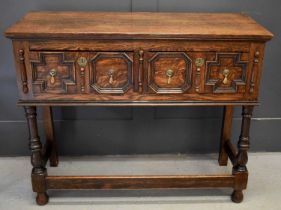 A 17th century style oak sideboard, with two short geometric moulded drawers, raised on turned