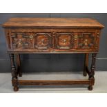 A 17th century style oak sideboard, with two short geometric moulded drawers, raised on turned