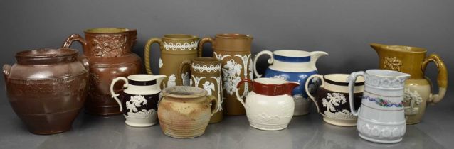 A large group of antique jugs, to include Victorian examples, one modelled with Royal Crest,
