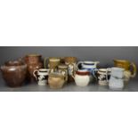 A large group of antique jugs, to include Victorian examples, one modelled with Royal Crest,