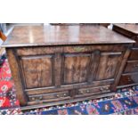 An 18th century style oak 'mule chest' TV cabinet, the top lifts up to reveal a section where a TV