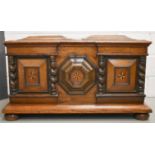 A Dutch oak coffer, circa 1840, the break front centred by a relief moulded octagonal panel inlaid