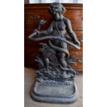 A cast iron umbrella stand in the form of a cherub and snake.