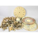 A group of clock parts to include an early 19th century brass clock face signed Edw Butler of