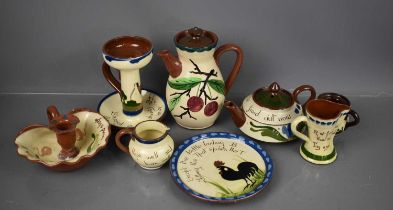 A group of Torquay ware, to include jug, chamber sticks, hot water pot, dish and other examples.