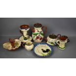 A group of Torquay ware, to include jug, chamber sticks, hot water pot, dish and other examples.