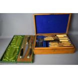 An oak cased canteen of cutlery together with a vintage carving set in the original presentation