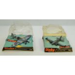Two Dinky Toys diecast models of a Hurricane MkII and a U.S Army T 42A, model numbers 718 and 712,