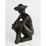 A bronze style sculpture, nude woman wearing a hat.