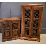 Two hardwood food cabinets, possibly Indonesian, with lattice work panels, enclosing interior