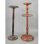 A 1950s oak ashtray stand together with a mahogany example.
