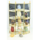 A collection of eleven Franklin Mint "The Collector's Treasury of Eggs" with display cabinet.