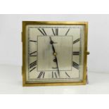 An Art Deco period Mercer wall clock, of square form, the wooden case with brass glazed door