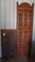 A bi-fold Indonesian hardwood carved screen, together with a carved panel, the screen measures 182cm