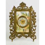 A French brass and porcelain table clock, the Arabic dial set within a porcelain plaque painted with