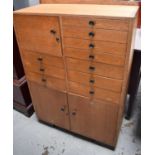 A mid century beech haberdashery cabinet, comprising various drawer and cupboard doors. 106cms